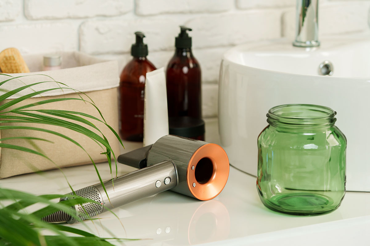 hair dryer and jar on bathroom counter