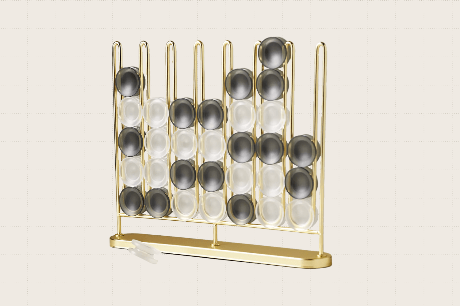 A sculptural game of Four-in-a-Row made from metal (gold finish) and frosted black and white playing pieces. It's 12.5 inches wide, and nearly 11 inches tall.