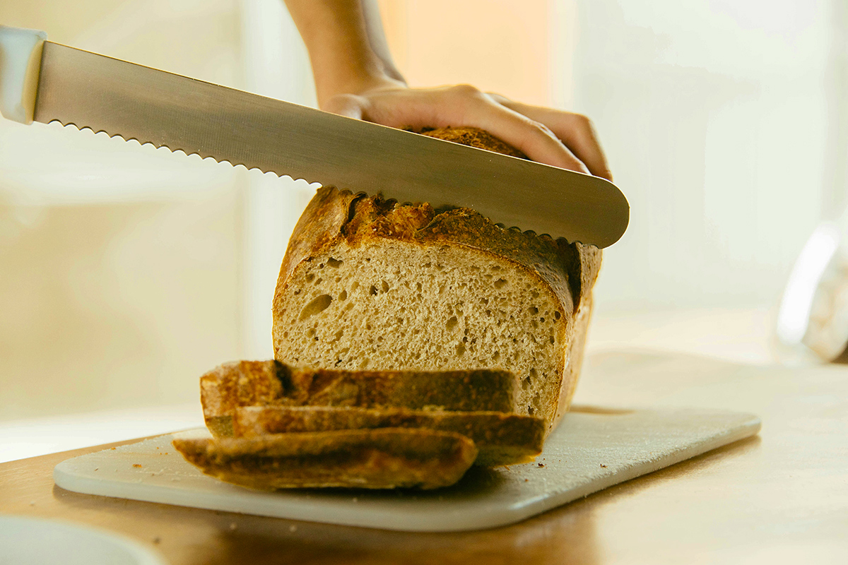 Cutting a slice of bread with a knife