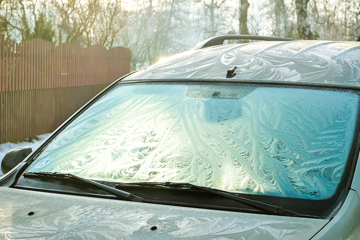 Frozen windshield of a car on cold winter day